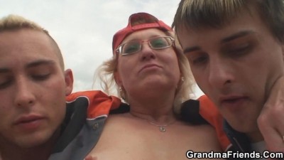 Blonde old Woman Pleases two Strangers in the Fields